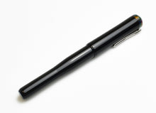 Load image into Gallery viewer, A Franklin-Christoph Model 02 Intrinsic Black Cathedral fountain pen with a closed cap rests on a white background.