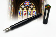 Load image into Gallery viewer, Franklin-Christoph Model 02 Intrinsic Black Cathedral fountain pen with hard acrylic cap, #6 nib before stained glass.
