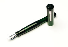 Load image into Gallery viewer, A Franklin-Christoph Model 02 Intrinsic Solid Emerald fountain pen, uncapped and resting on a white surface.