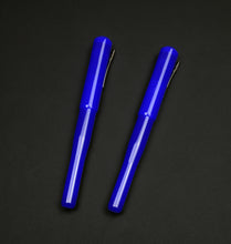 Load image into Gallery viewer, Two Franklin-Christoph Model 02 Intrinsic Kyanite pens with #6 nibs lie parallel on a plain black surface.