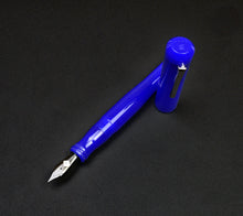 Load image into Gallery viewer, A Franklin-Christoph Model 02 Intrinsic Fountain Pen - Kyanite with bent barrel rests, cap upright, on a dark surface.