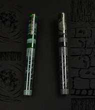 Load image into Gallery viewer, Two Franklin-Christoph pens, green and black, rest on black near A.A. Vacharat Engraved Art Model 03 - Secret Garden.