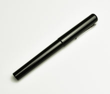 Load image into Gallery viewer, A Franklin-Christoph Model 03 Iterum fountain pen in Black Cathedral rests diagonally on a white background.