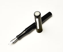 Load image into Gallery viewer, A Franklin-Christoph Model 03 Iterum Black &amp; Creme fountain pen rests on a white background.