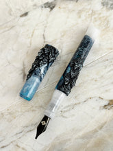 Load image into Gallery viewer, Franklin-Christoph 03M A.A. Vacharat Terrain pen, smooth blue-white with black leaf motif, rests on marble.