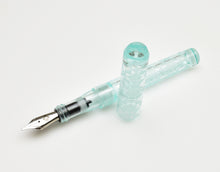 Load image into Gallery viewer, A Franklin-Christoph Model 03M Antique Glass Abstract Diamond Etched FP SE rests on a white surface.