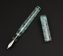 Load image into Gallery viewer, A Franklin-Christoph Model 03M Antique Glass Abstract Diamond fountain pen, uncapped on a sleek black surface.