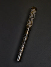 Load image into Gallery viewer, The Franklin-Christoph 03M SCF Artisan Engraved Ancienne rests on a dark surface, its silver pattern shining.