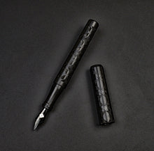 Load image into Gallery viewer, Franklin-Christoph 03M Artisan Delrin - Diamond Abstract fountain pen uncapped on a dark textured surface.