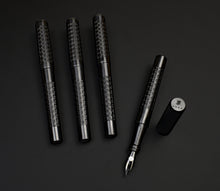 Load image into Gallery viewer, Four black Franklin-Christoph 03M Artisan Delrin - Kumiko pens, one uncapped, with patterned barrels.