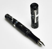 Load image into Gallery viewer, A Franklin-Christoph Model 19 - Dark Room Emulsion, cap removed, rests on white in black and gray marbling.