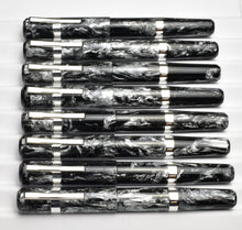Load image into Gallery viewer, Nine Franklin-Christoph Model 19 Dark Room Emulsion pens align horizontally in a white display case.
