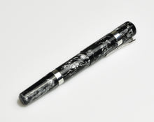 Load image into Gallery viewer, A Franklin-Christoph Model 19 Fountain Pen - Dark Room Emulsion gleams on a white surface, aluminum bands polished.