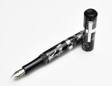 Load image into Gallery viewer, A Franklin-Christoph Model 19 Fountain Pen - Dark Room Emulsion, cap off, lies on a white surface.