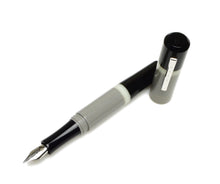 Load image into Gallery viewer, A Franklin-Christoph Model 19 Fountain Pen - GCB with a silver #6 nib and gray barrel rests next to its cap.