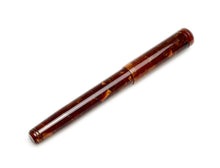 Load image into Gallery viewer, A closed Franklin-Christoph Model 20 Marietta Fountain Pen—Autumn Oak rests on a marbled brown body over white.