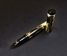 Load image into Gallery viewer, A Franklin-Christoph Model 20 Marietta Fountain Pen - Cold Brew SE, uncapped, sits on a dark textured surface.