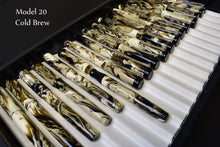 Load image into Gallery viewer, Franklin-Christoph Model 20 Marietta Fountain Pen - Cold Brew SE features swirling acrylic hues in a display case.