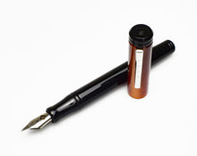 Load image into Gallery viewer, An uncapped Franklin-Christoph Model 20 Marietta - Copper Rising fountain pen rests on a white background.