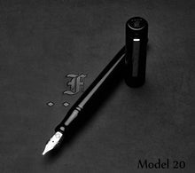 Load image into Gallery viewer, A Franklin-Christoph Model 20 Marietta Onyx fountain pen uncapped rests on a dark surface near its name.