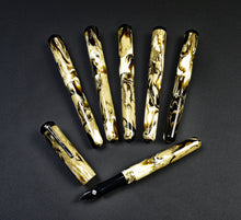 Load image into Gallery viewer, Seven Franklin-Christoph Model 31 Omnis Cold Brew SE pens with marbled patterns arranged on a dark background.