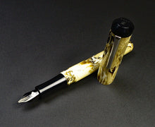 Load image into Gallery viewer, Marbled yellow-brown Model 31 Omnis - Cold Brew SE by Franklin-Christoph, cap off, on a dark textured surface.