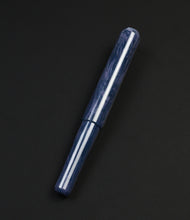 Load image into Gallery viewer, A Franklin-Christoph Model 40 Panther Indigo Black SE fountain pen rests diagonally on a plain black background.