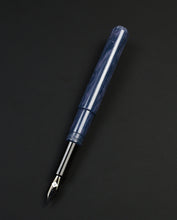 Load image into Gallery viewer, A Franklin-Christoph Model 40 Panther Indigo Black Special Edition fountain pen rests diagonally on a black background.