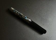 Load image into Gallery viewer, The 40M SCF Art Silver-Blue Fountain Pen by Franklin-Christoph lies diagonally, displaying marbled elegance.