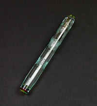 Load image into Gallery viewer, A Franklin-Christoph Model 45 Cor Antique Glass Cathedral Pen lies diagonally on a dark, textured surface.