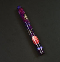 Load image into Gallery viewer, A Franklin-Christoph Cosmic Cats pen by Vacharat rests on a dark surface, showcasing its unique galaxy-themed design.