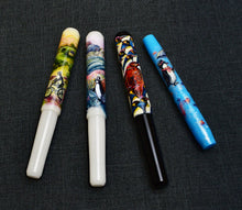 Load image into Gallery viewer, Four Franklin-Christoph “Pesto Penguin” pens with whimsical artwork, including a large penguin, on dark textured background.