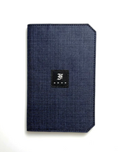 Load image into Gallery viewer, A navy 5.3 Pocket Notebook Cover by Franklin-Christoph features a black patch with a white stylized F on the cover.
