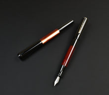 Load image into Gallery viewer, A Franklin-Christoph Model 55 Pentium Copper Rising fountain pen with cap beside it on a plain black background.