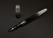 Load image into Gallery viewer, Franklin-Christoph 66 Nishihara Maki-e Artist Proof FP, black with white mosaic, uncapped, cap nearby on dark surface.
