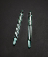 Load image into Gallery viewer, Two Franklin-Christoph Model 66 Septagonal Antique Glass pens with caps, parallel on a dark background.