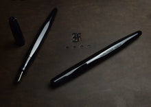Load image into Gallery viewer, Two Franklin-Christoph Model 66 Onyx pens shown, one uncapped with block threads and stylized F in the center.
