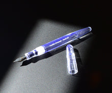 Load image into Gallery viewer, A Franklin-Christoph Model 66 Septagonal in Italian Ice glows, uncapped, on black under a beam of light.
