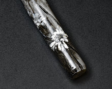 Load image into Gallery viewer, Franklin-Christoph’s 03M A.A. Vacharat Flowers on Snow fountain pen lies on a dark, textured surface—unique artistry.