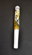 Load image into Gallery viewer, A ceramic lion-face pipe sits beside a Franklin-Christoph 40M A.A. Vacharat Red Fox on Snow pen on a dark surface.