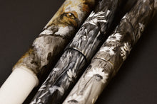 Load image into Gallery viewer, Three painted candles, one with a brown, yellow, and black face like Franklin-Christoph’s Red Fox on Snow pen.