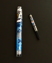 Load image into Gallery viewer, Franklin-Christoph 46 - A.A. Vacharat The Ice Fisher fountain pen with ink converter rests on a black background.