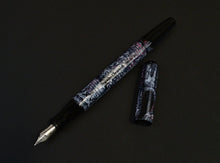 Load image into Gallery viewer, The Franklin-Christoph 65 A.A. Vacharat Medieval Castle, uncapped with #5 nib, rests on a dark surface.
