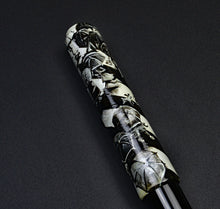 Load image into Gallery viewer, A Franklin-Christoph 40M A. A. Vacharat Rush Hour Rain pen with black and white pattern rests on a smooth surface.