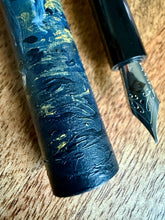 Load image into Gallery viewer, Close-up of a Franklin-Christoph 33 A.A. Vacharat Moby Whale pen with marbled blue and yellow cap on wood surface.