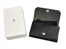 Load image into Gallery viewer, Franklin-Christoph Business Card Case - Italian Leather, black, shown with cards and white box with minimal black logo.
