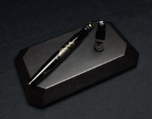 Load image into Gallery viewer, The Franklin-Christoph Model 66 Diamondback Dragon LE FP, uncapped, rests on dark wood with black and gold accents.
