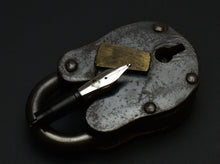 Load image into Gallery viewer, A Franklin-Christoph #6 Nib Unit rests on an old brass padlock, set against a black background.
