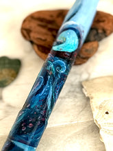 Load image into Gallery viewer, Close-up of the Franklin-Christoph Model 46 fountain pen. Original art by A.A. Vacharat. Kraken pen with swirling blue patterns on a light surface.