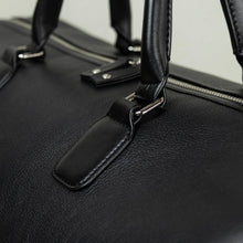 Load image into Gallery viewer, Close-up of Franklin-Christoph Duffle Bag - Black Leather with silver zipper—ideal for weekend getaways.